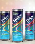 Three cans of Do'mo drinks with different flavors: Ginger Miso Mule, Spicy Watermelon Margarita, and Scrumptious Berry Bramble