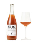 Bottle and glass of NON alcoholic beverage on a white background