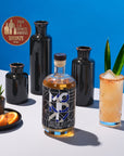 Bottle of MO Bar Creme 701 with a cocktail and decorative elements on a blue background