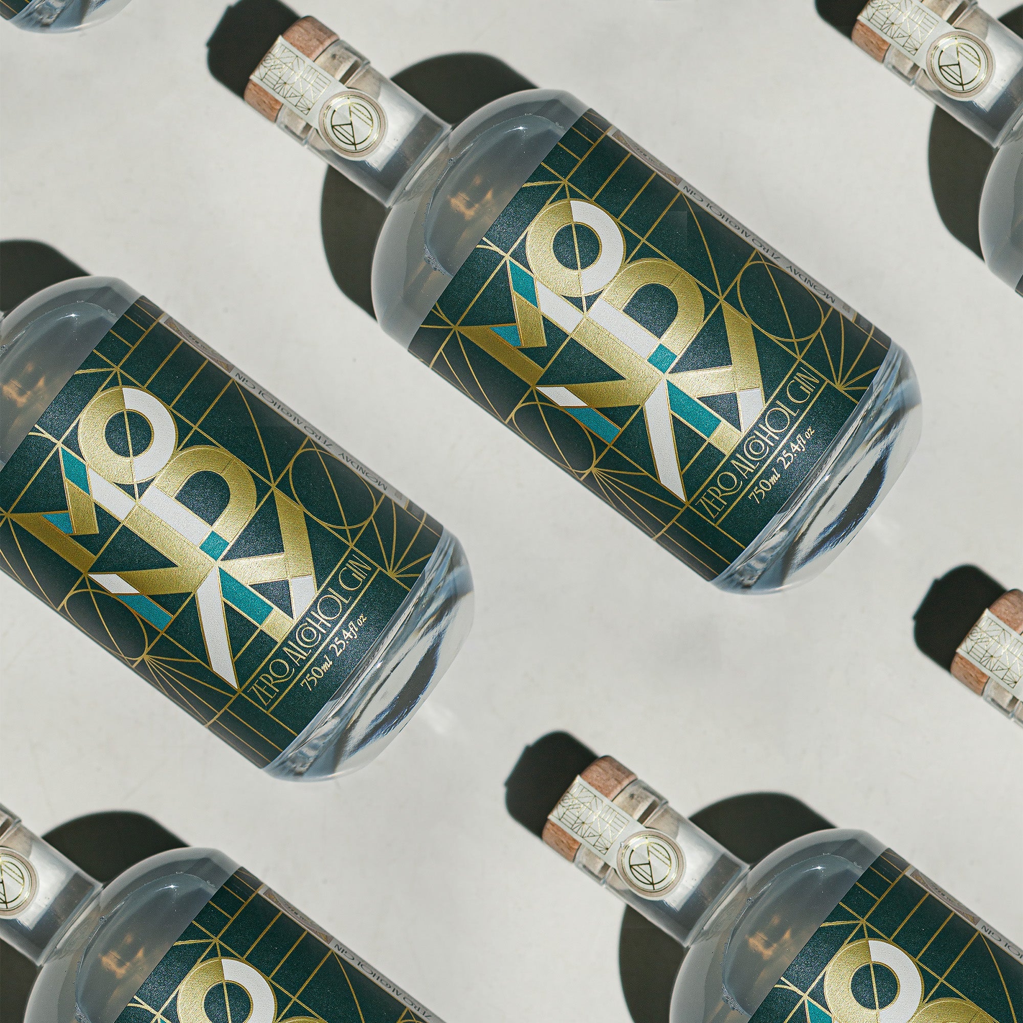 Multiple bottles of Proximo tequila with a geometric label on a reflective surface.