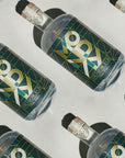 Multiple bottles of Proximo tequila with a geometric label on a reflective surface.