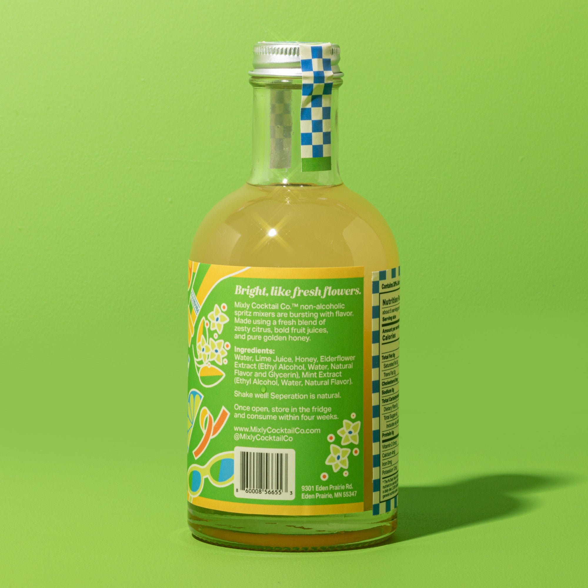 Bottle of juice with a label on a green background