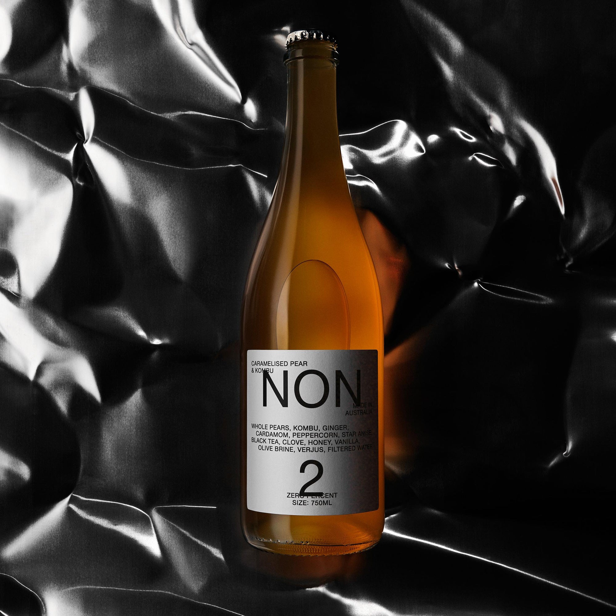 Bottle of 'NON' beer with a label on a black and white textured background