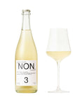 Bottle and glass of white wine with 'NON' label on a white background
