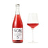 Bottle and glass of red NON alcoholic beverage on a white background