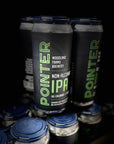 Multiple cans of Pointer Non-Alcoholic IPA with blue lids on a dark background