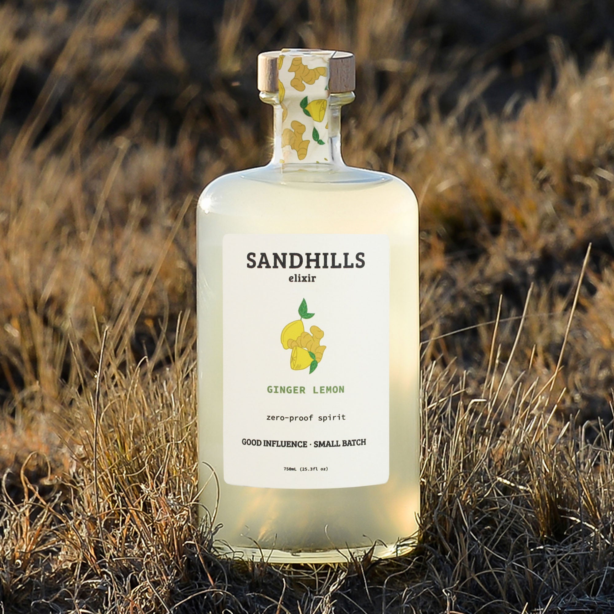 Bottle of Sandhills elixir ginger lemon spirit in a natural setting