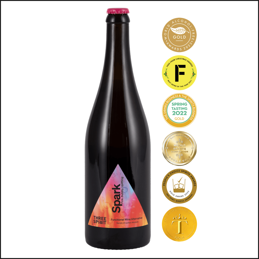 Black bottle of &#39;Three Spirit&#39; wine with colorful label and multiple gold awards on a white background