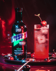 Bottle of 'Three Spirit Cherry Love' with a cocktail garnished with a cherry on a dark background