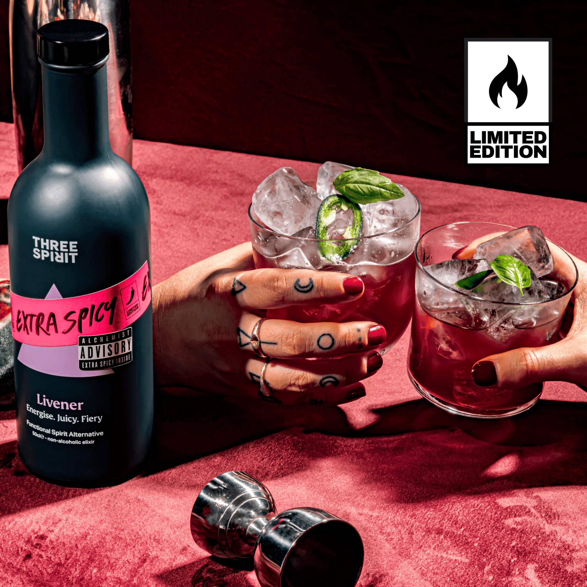 Bottle of &#39;Three Spirit&#39; Extra Spicy 21 with two cocktails on a red surface, featuring a &#39;Limited Edition&#39; logo.