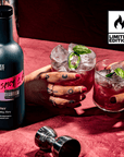 Bottle of 'Three Spirit' Extra Spicy 21 with two cocktails on a red surface, featuring a 'Limited Edition' logo.