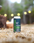 Non-alcoholic IPA can on hay with blurred outdoor background